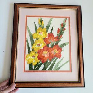 Large framed floral embroidery.